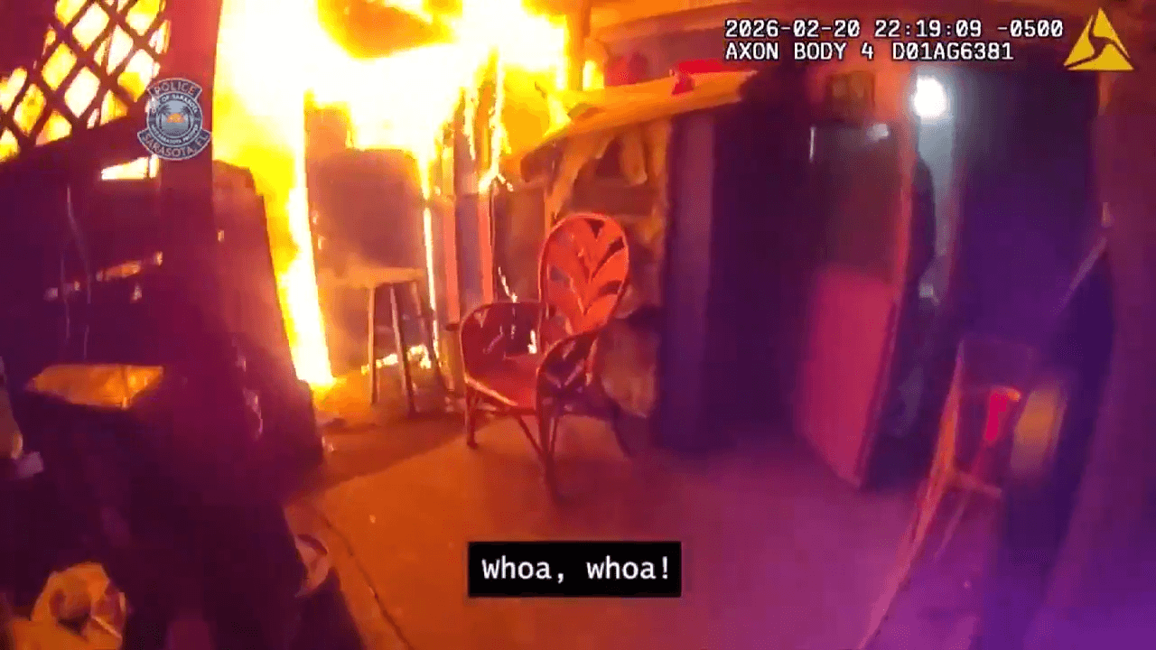 Body camera footage shows Sarasota Police pulling 2 people from burning home