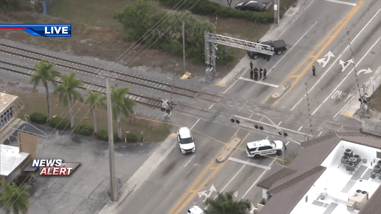 Police shut down railroad crossing near Dixie Highway and NE 26th St in Wilton Manors after train fatally strikes pedestrian