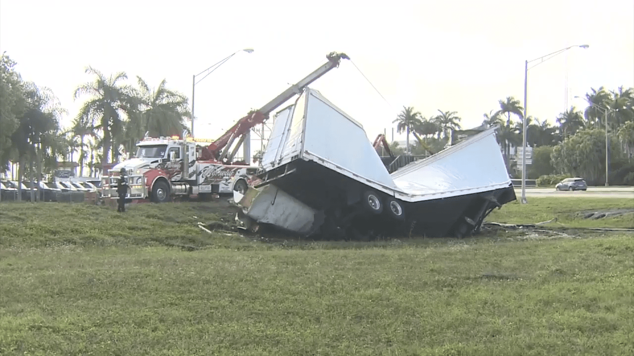 Tractor trailer overturns in Sunrise, shutting down lane of traffic as crews remove vehicle
